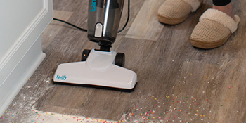 Simplicity Spiffy vacuuming dust on hard floor